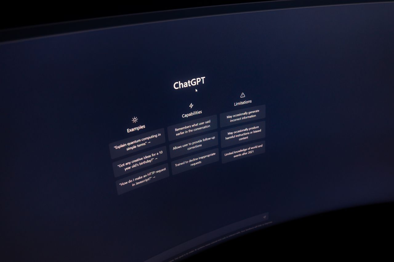 home-hero-bg Close-up of a computer screen displaying ChatGPT interface in a dark setting.