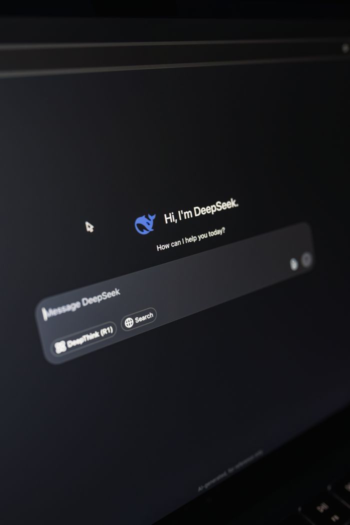 home-services-02 Close-up of a laptop displaying an AI interface with a chatbot prompt in dark mode.